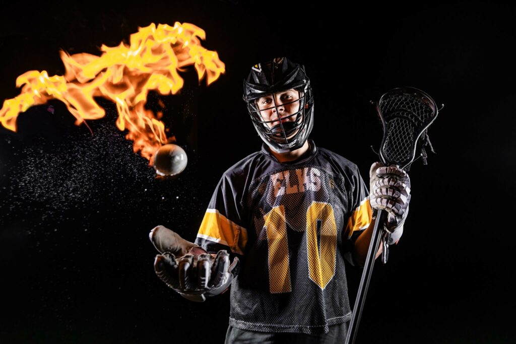 Seth Alejandrino, a senior at Centerville High School, tosses a fiery lacrosse ball in the air while sporting the school's all-black Elks uniform.